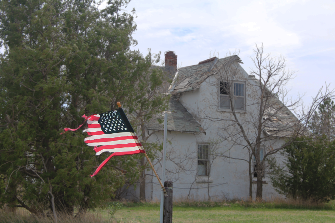 fraying american flag blowing in the wind